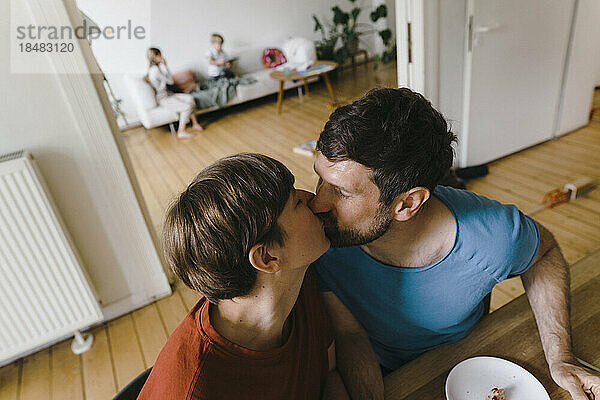 Mature romantic couple kissing each other at home