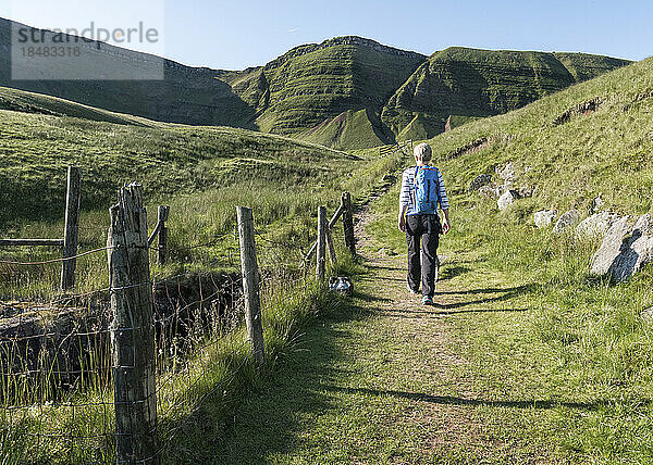 Woman hiking on mountain at sunny day  Brecon Beacons  Wales