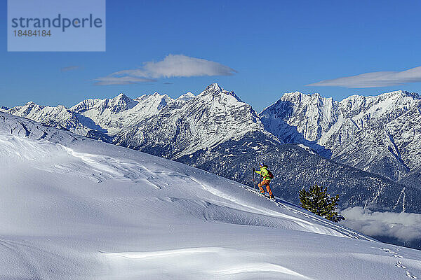 Austria  Tyrol  Female skier ascending snowcapped slope in Tux Alps