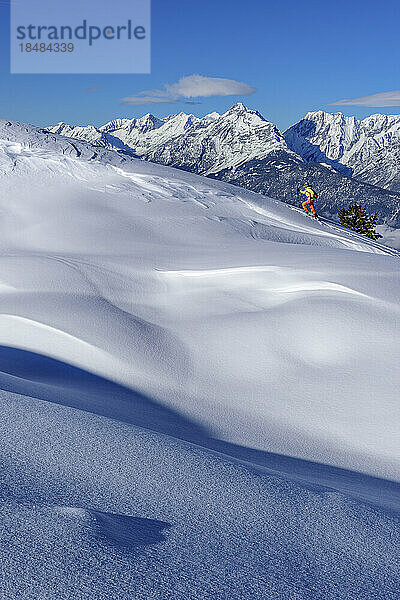 Austria  Tyrol  Female skier ascending snowcapped slope in Tux Alps