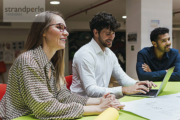 Smiling business colleagues having a meeting in office