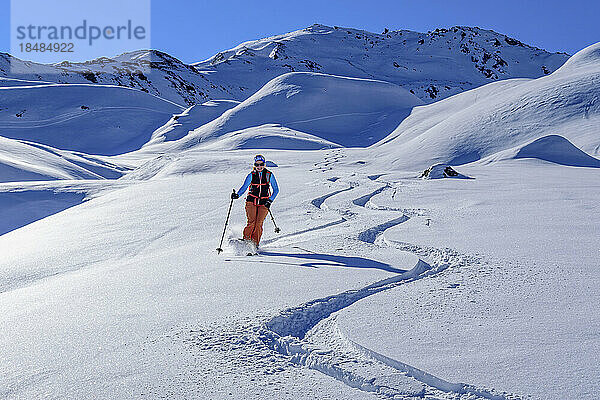 Austria  Tyrol  Female skier sliding down snowcapped slope in Tux Alps