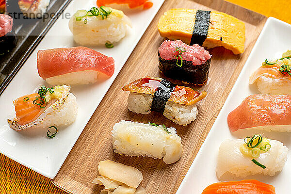 Sushi-Platte  eine Auswahl an rohem Fisch und Reissnacks mit Stäbchen.