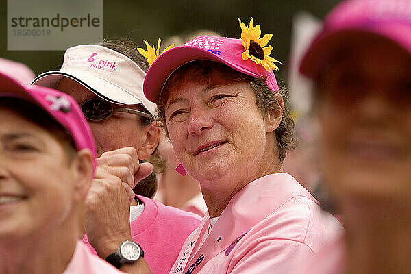 Breast cancer survivor cheers at the finish of a breast cancer walk in San Francisco.