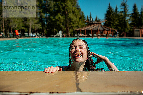 Glückliches Teenager-Mädchen am Pool