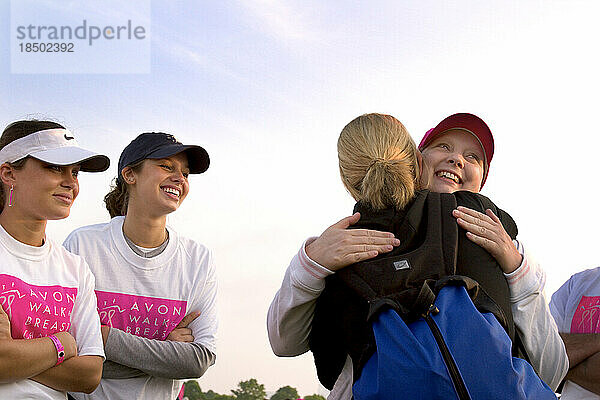 Breast cancer survivor gets a hug from fellow walkers.