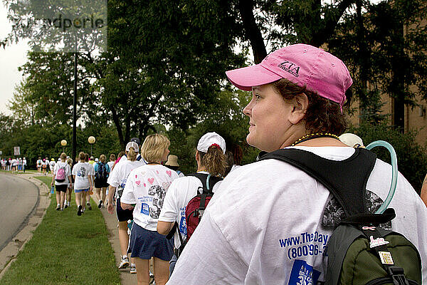Woman with camel back sets out on a breast cancer walk in Detroit.