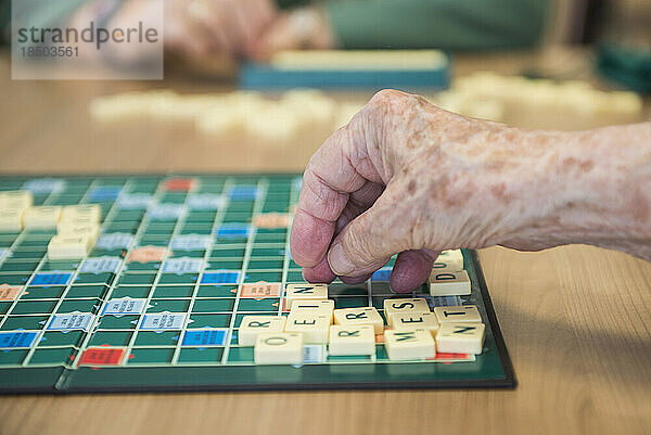 Ältere Frau spielt Brettspiel im Altersheim