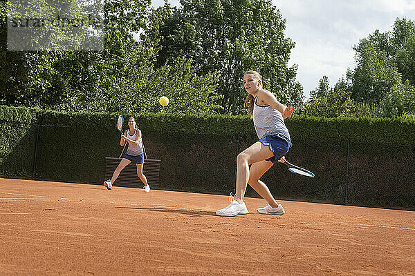 Zwei Frauen spielen Tennis an einem sonnigen Tag  Bayern  Deutschland