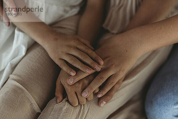 Close up of family's hands intertwined