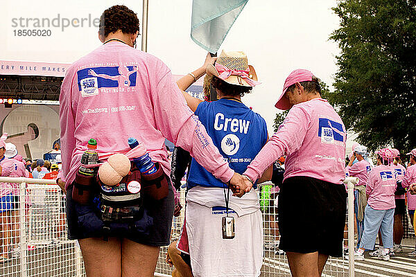 Walkers have a solemn moment at the close of a breast cancer walk in Washington  DC.