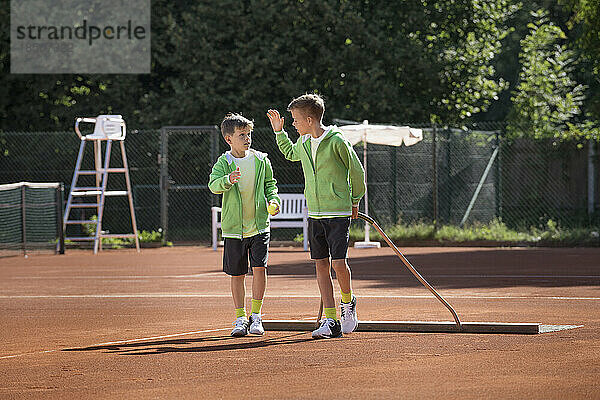 Zwei kleine Jungen bereiten einen Tennisplatz vor  Bayern  Deutschland