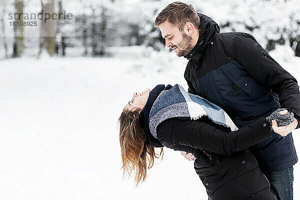 Liebespaar tanzt im verschneiten Park