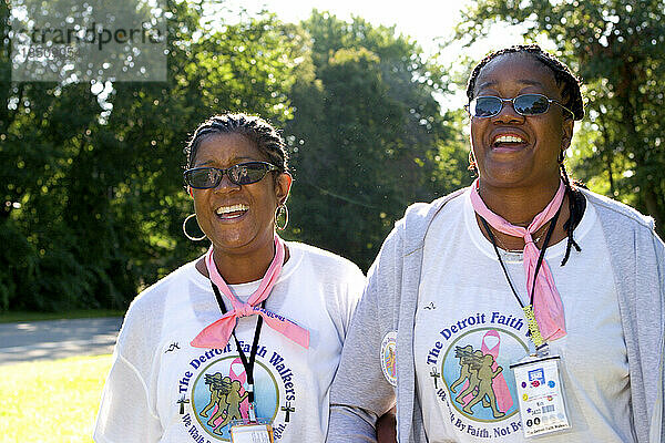 Two African-American women walk in a Detroit breast cancer walk.