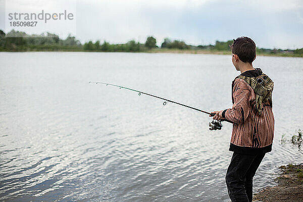 Junge angelt alleine im Teich