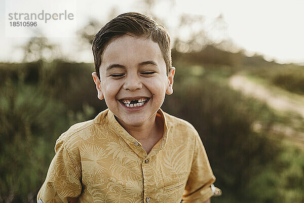 Porträt eines Jungen im schulpflichtigen Alter  dem zwei Vorderzähne fehlen  mit geschlossenen Augen