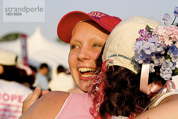 Breast cancer survivor is embraced after a breast cancer walk.