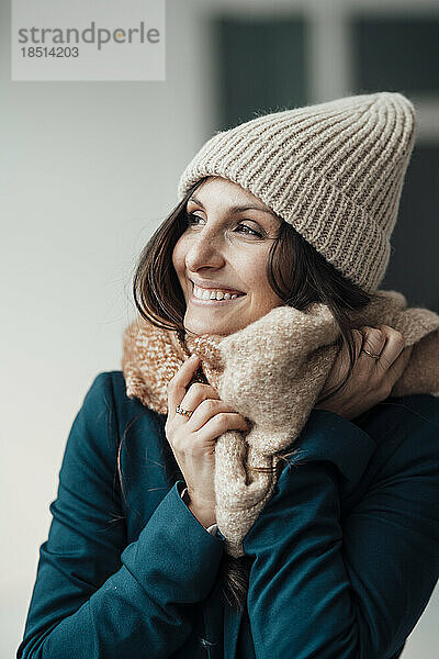 Happy young woman wearing knit hat