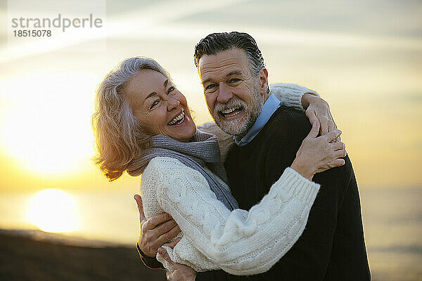 Cheerful mature couple having fun at beach