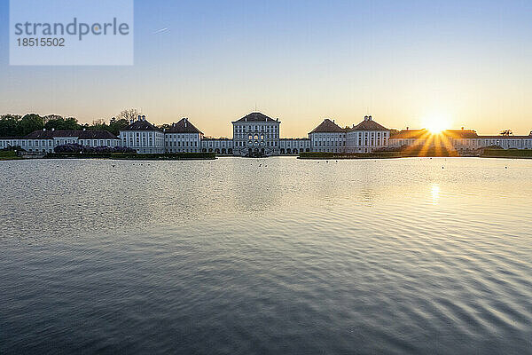 Germany  Bavaria  Munich  Lake in front of Nymphenburg Palace at sunset