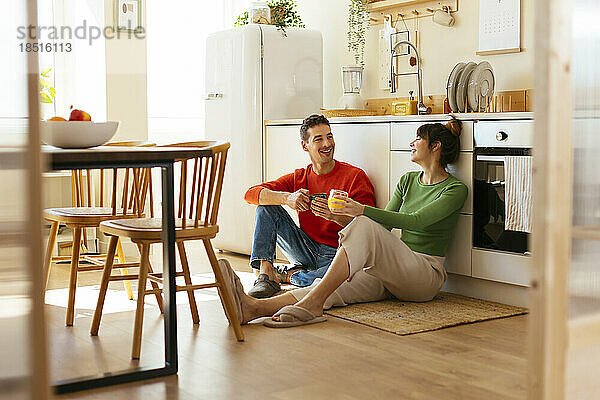 Happy couple spending leisure time in kitchen