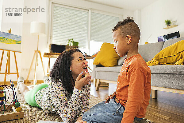 Glückliche Frau  die mit ihrem Sohn spricht und es zu Hause genießt