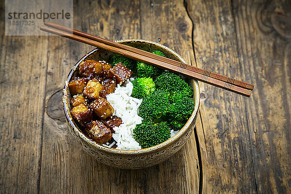 Bowl of coconut rice with tofu  broccoli and sesame seeds