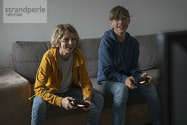 Friends playing video game at home