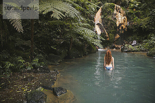 Woman standing in natural thermal water