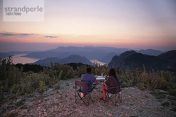 Couple having dinner together at sunset