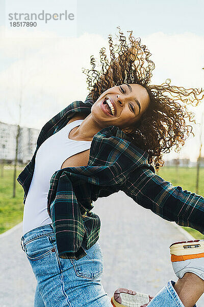 Cheerful young woman jumping and having fun
