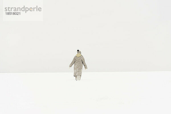 Woman walking on snow in winter