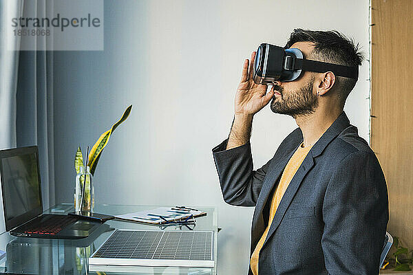Geschäftsmann passt Virtual-Reality-Headset im Heimbüro an