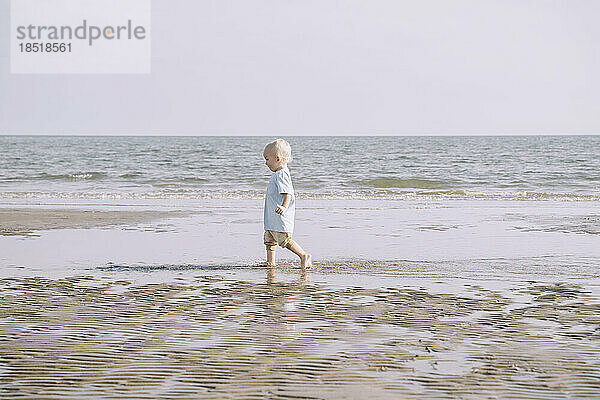 Boy with blond hair enjoying at beach