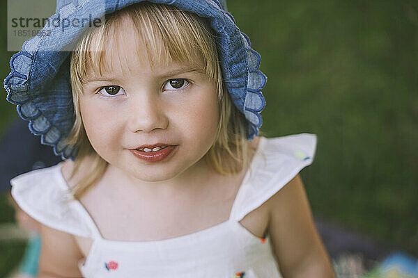 Cute girl with blond hair wearing hat