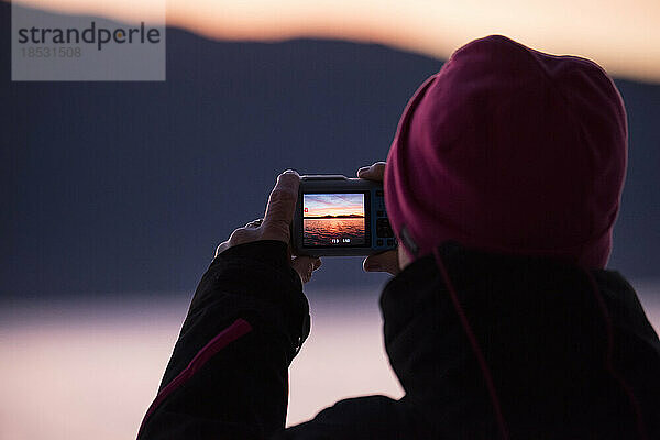 Bei Sonnenaufgang hält eine Person mit einer einfachen Kamera den Moment auf der Inside Passage fest; Inside Passage  British Columbia  Kanada