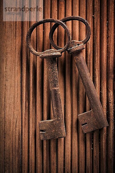 Zwei alte Schlüssel auf hölzernem Hintergrund. Ansicht von oben