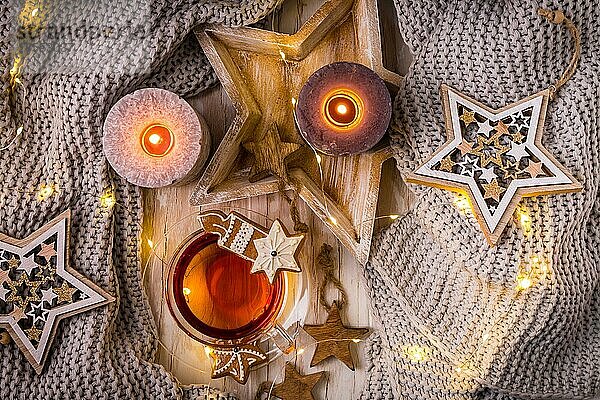 Gemütliches Zuhause und Hygge Konzept Tasse Tee mit Weihnachtsgebäck  warme Decke und Kerzen