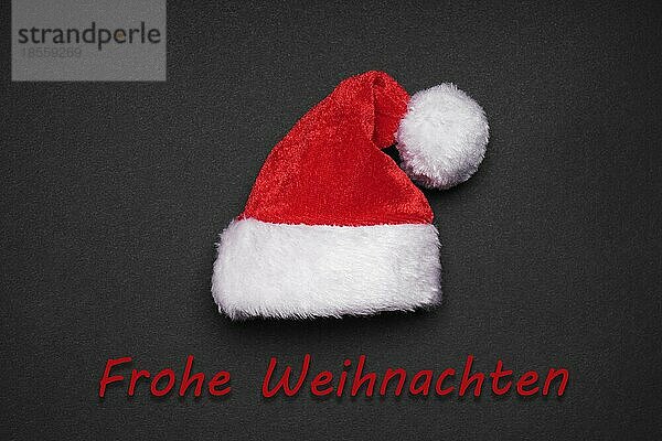 Frohe Weihnachten  Weihnachtskarte mit Weihnachtsmannmütze