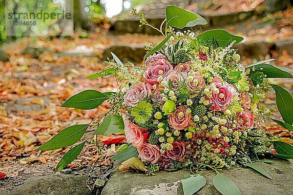 Brautstrauß rote Rosen mit Steintreppe und Laub