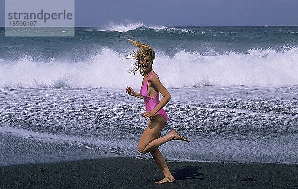 Junge Frau im Badeanzug am Strand Strandlauf  Wellen  Meer