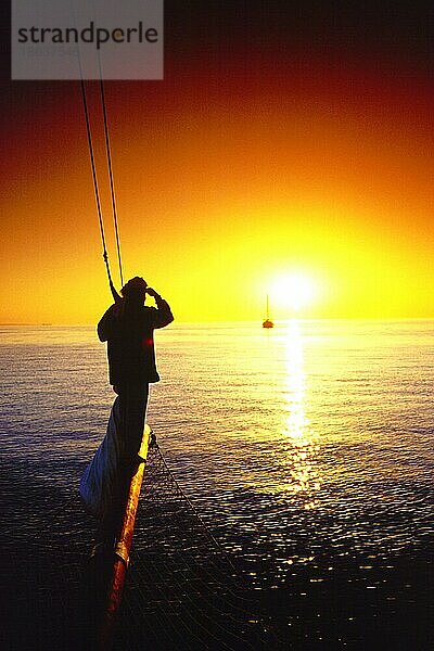 Man on Sailing Ship at sunset  Red Sea  Egypt  Mann an der Spitze eines Segelboots bei Sonnenuntergang  Rotes Meer  boat  Boot  Menschen  people  Stimmung  mood  vertical  Ägypten  Afrika