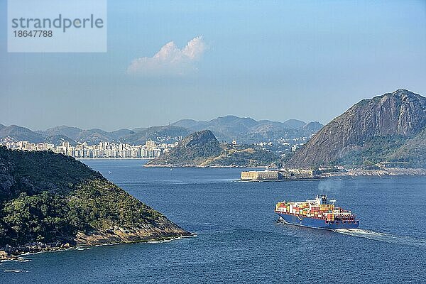 Frachtschiff bei der Einfahrt in die Guanabara Bucht durch die Berge und Wälder von Rio de Janeiro mit der Stadt Niteroi im Hintergrund  Brasilien  Südamerika