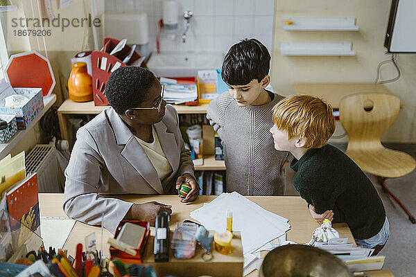 Lehrerin erklärt Schülern im Klassenzimmer