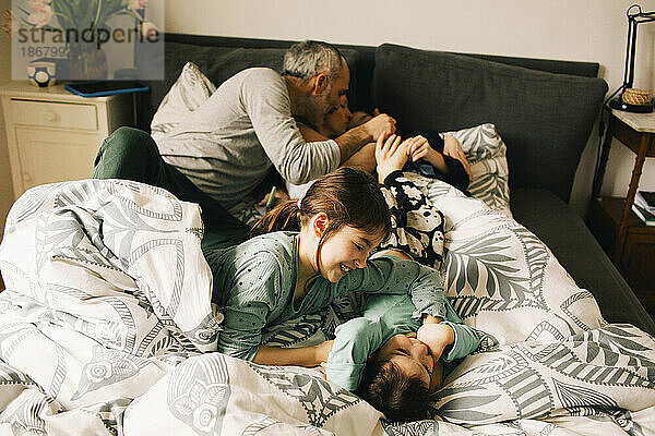 Hohe Winkel Ansicht der glücklichen Familie genießen mit einander auf Bett zu Hause