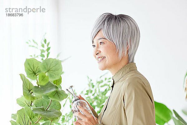 Ältere Japanerin bei der Gartenarbeit