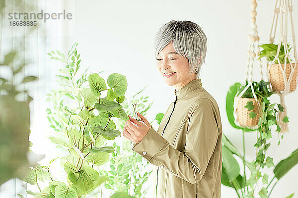 Ältere Japanerin bei der Gartenarbeit