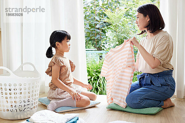 Japanese kid folding clothes