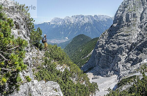 Bergsteiger beim Aufstieg zur Oberen Wettersteinspitze  hinten Karwendelgebirge mit Westlicher Karwendelspitze  Wettersteingebirge  Bayerische Alpen  Bayern  Deutschland  Europa