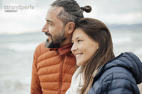 Happy woman with mature man at beach